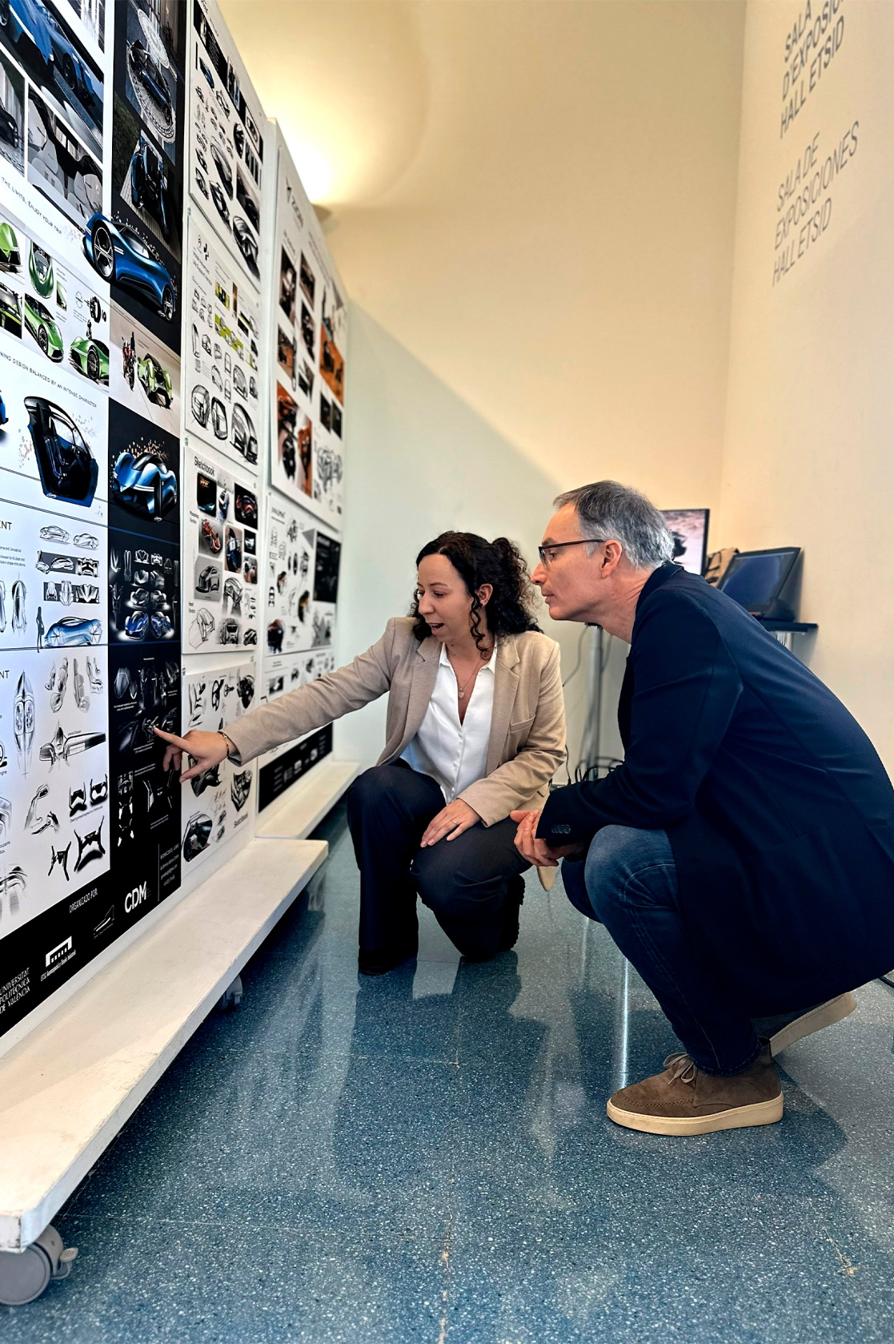 Guillermina Valdivia discussing automotive design sketches at an exhibition